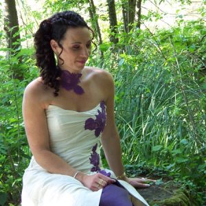 Robe de mariée en doupion de soie ivoire, ouverte sur jupon en organza de soie violet, ornée de dentelle violette